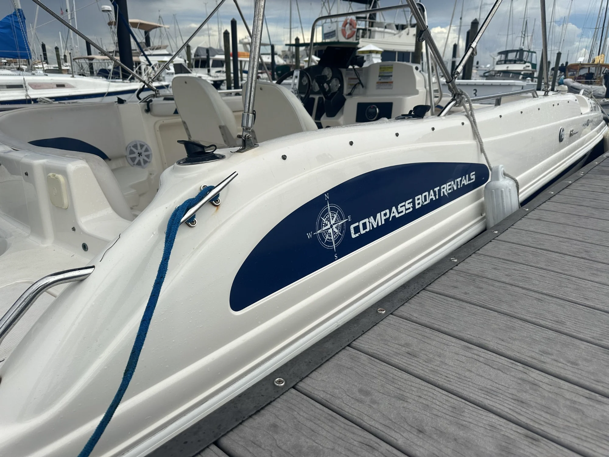 Compass Boat Rentals boat at a marina dock