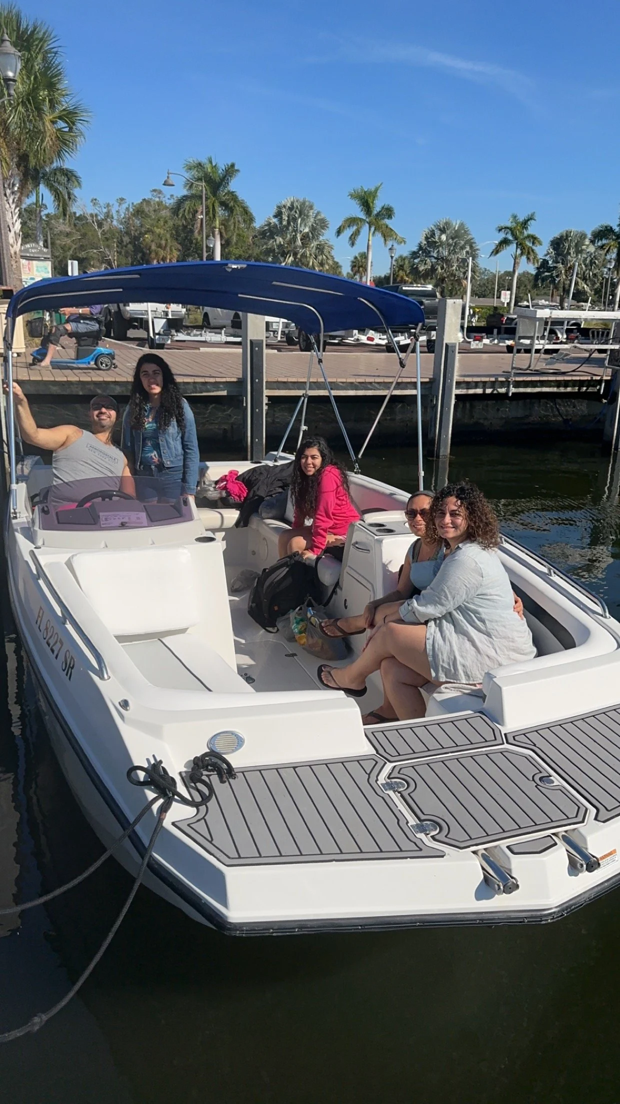 Guests seated in a boat beside a dock