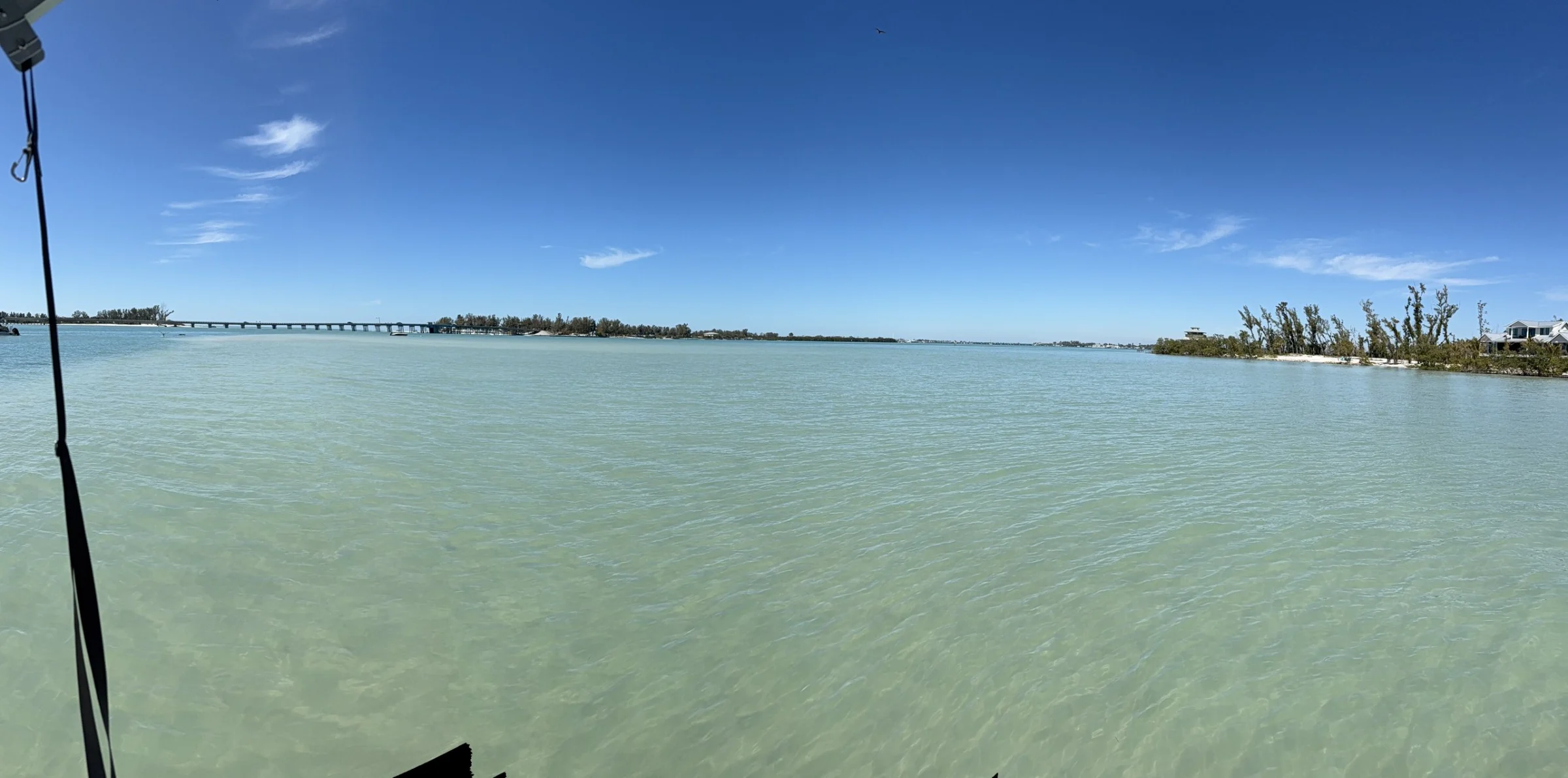 Shallow turquoise water and a low island near the Anna Maria Island sandbars