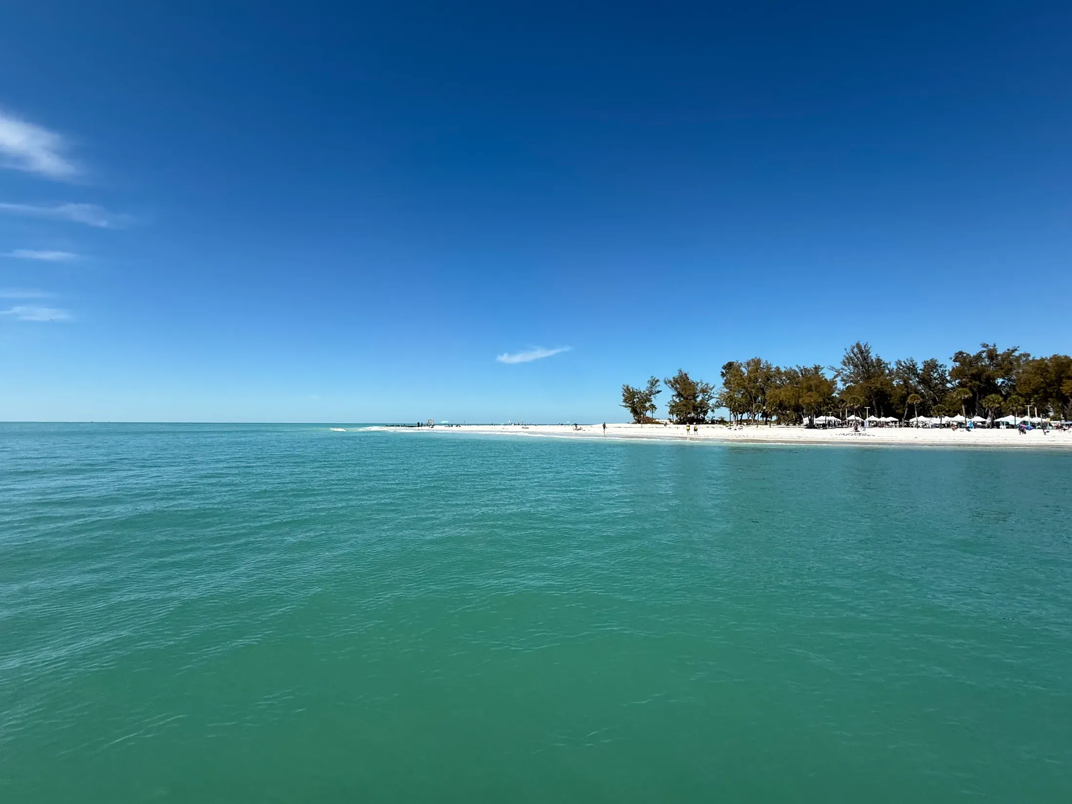Clear water beside a sandy island shore