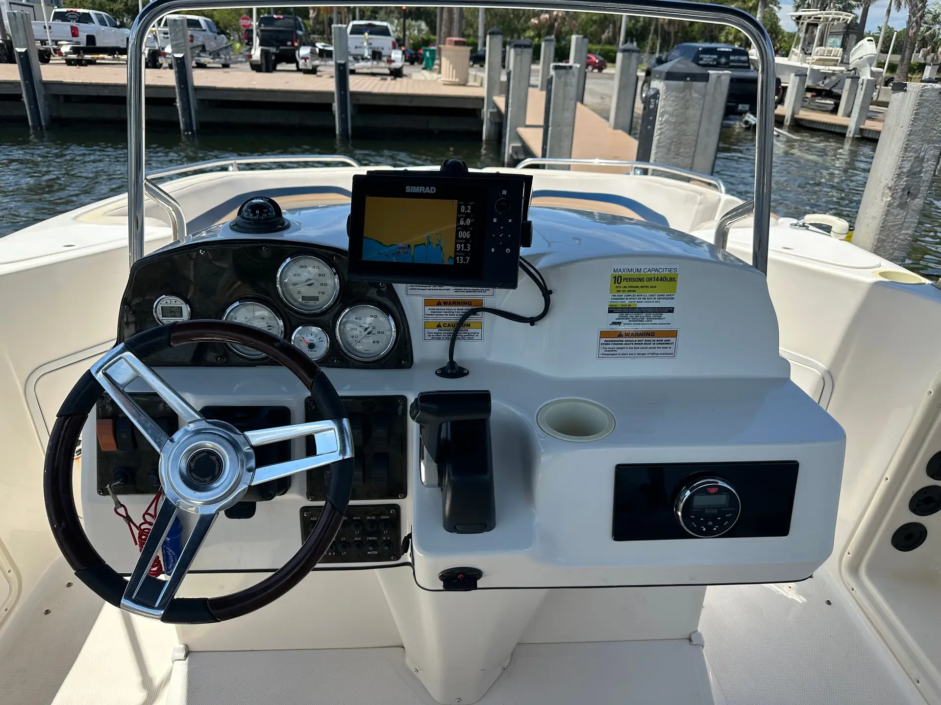The helm of a Compass rental boat with its GPS, depth finder and gauges, where the Florida boat rental rules are covered before departure on Anna Maria Island