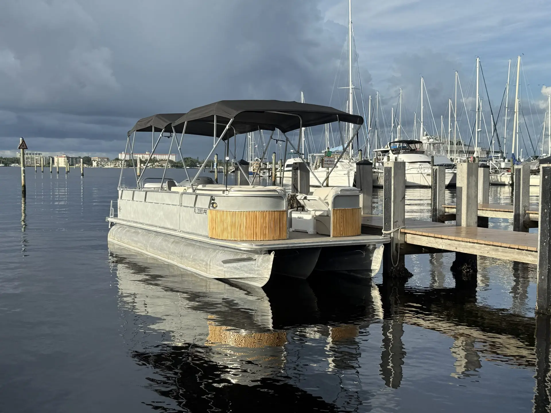 Anna Maria Island boat rentals from Compass, a tritoon tied up at the dock in Holmes Beach