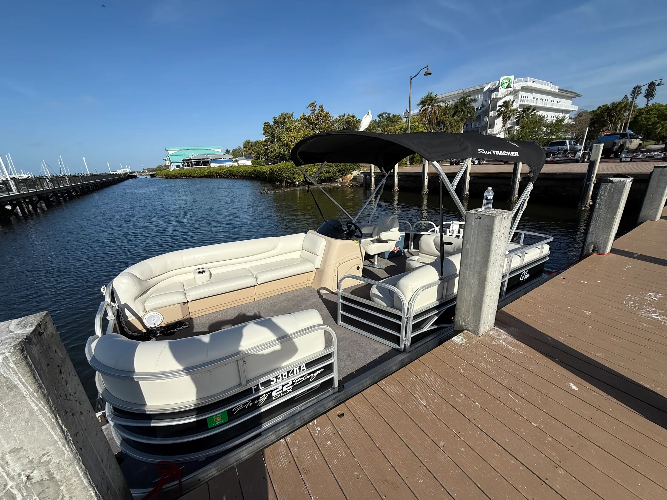 Pontoon boat alongside a waterfront dock