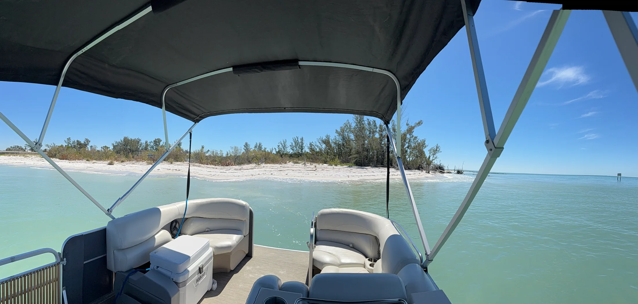 Shaded boat seating overlooking turquoise water