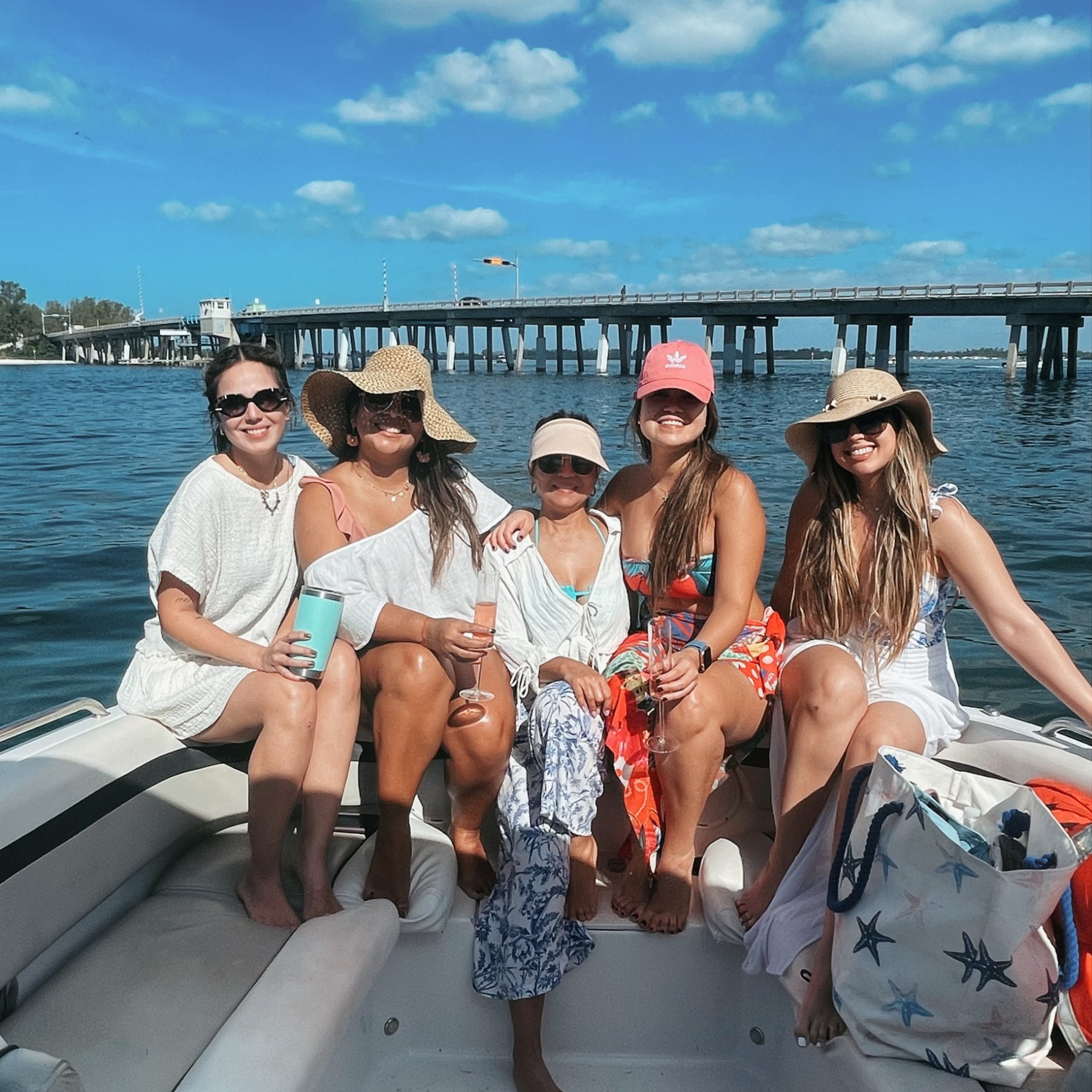 a group of people in a deck boat on a body of water