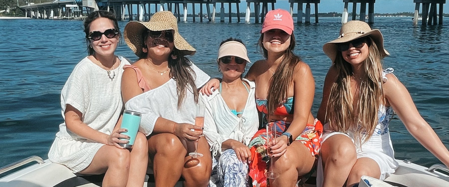 a group of people in a deck boat on a body of water