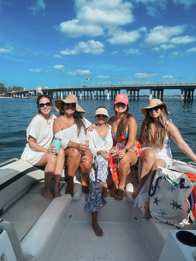 a group of people in a deck boat on a body of water