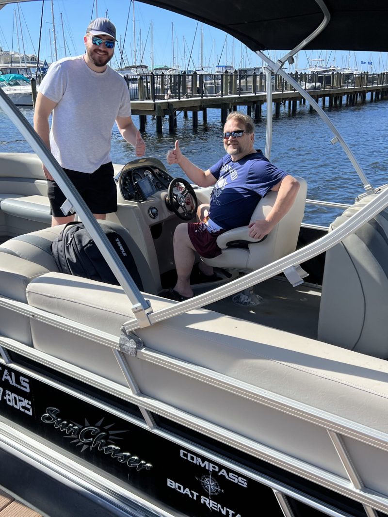 a group of people on a deck boat