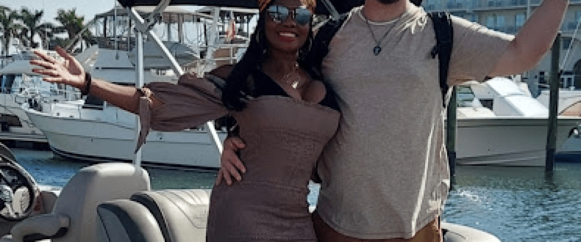 a couple of people that are standing in front of a pontoon