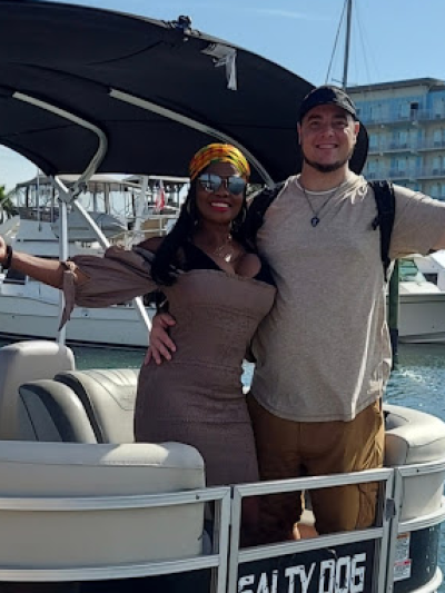 a couple of people that are standing in front of a pontoon
