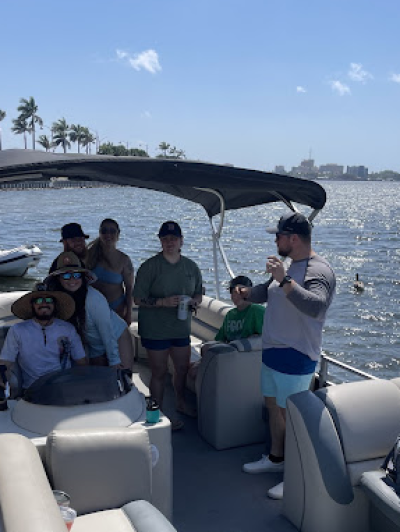 a group of people in a deck boat on a body of water